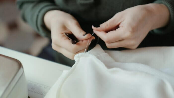 A person sewing clothes