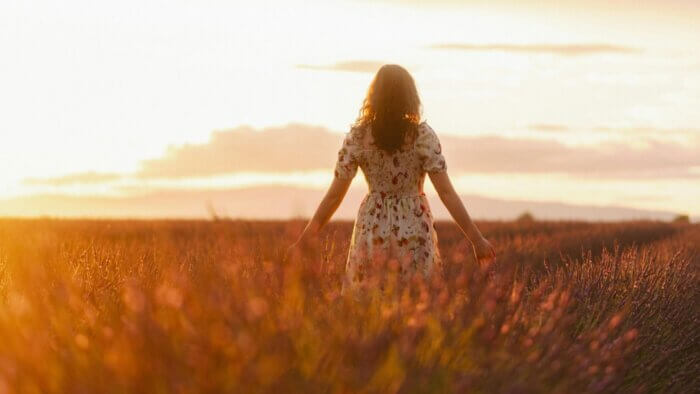 A woman walking in a lavender field