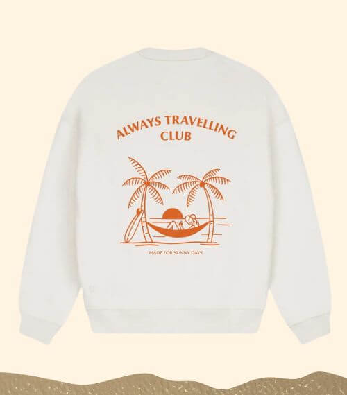 A white plant wool jumper with the words "Always Travelling Club" on it